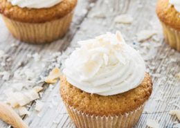 Coconut cupcakes topped with vanilla cream cheese frosting